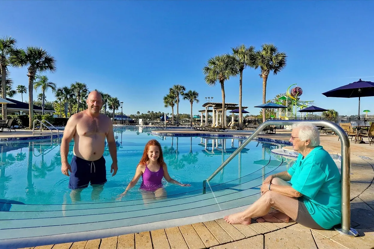 A dad, daughter and grandma enjoying the Windsor Hills Resort lagoon pool