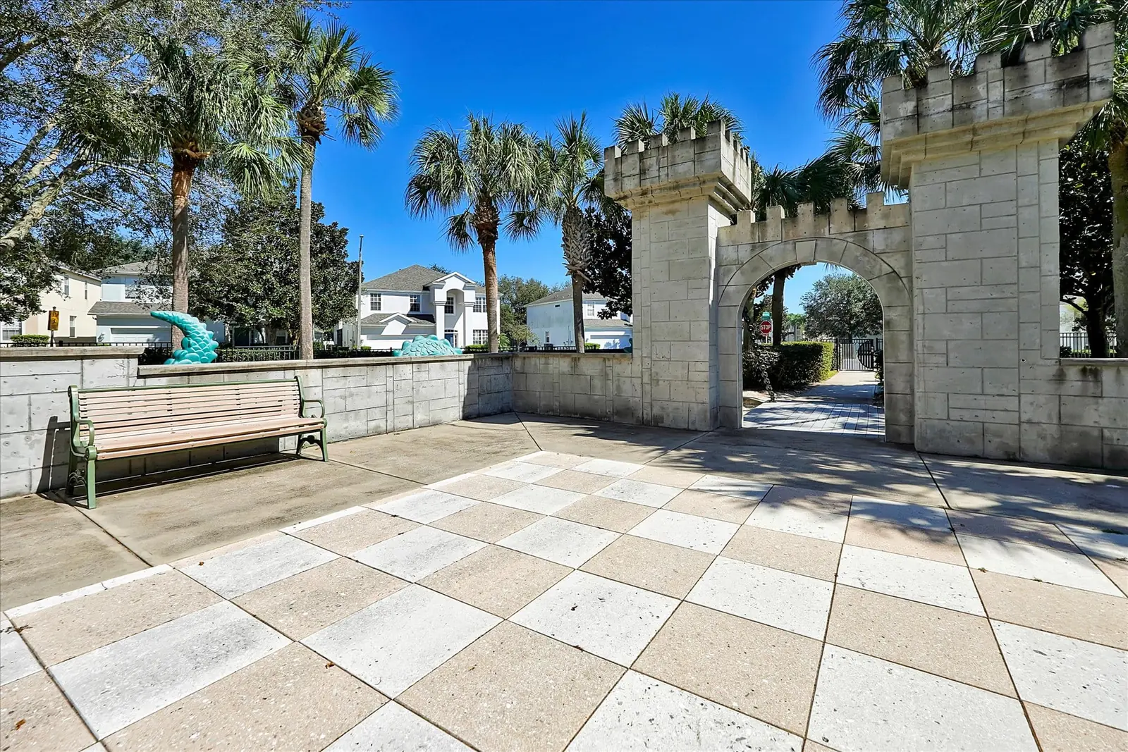 A stone archway plaza lined with palm trees at Windsor Hills Resort