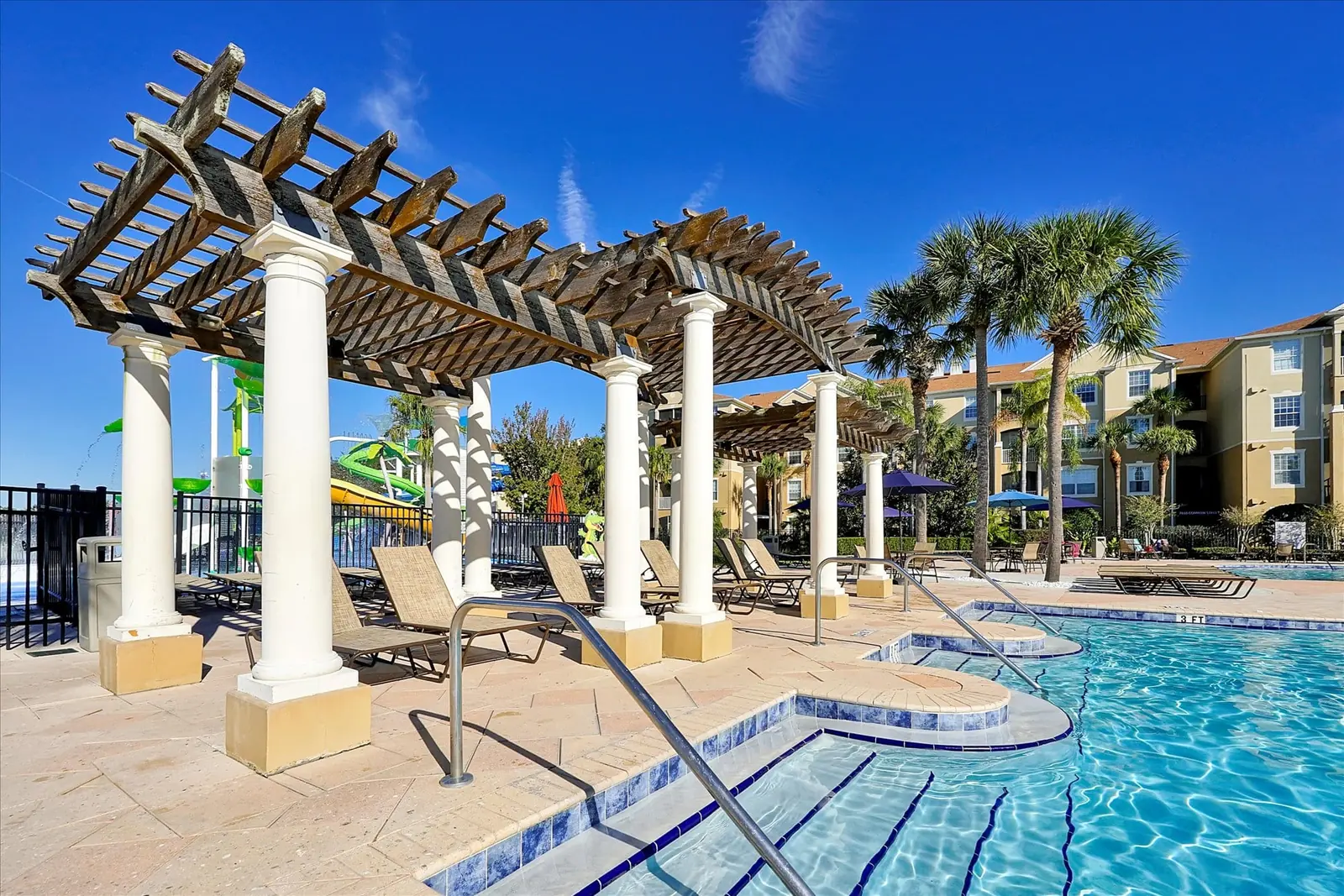 The Windsor Hills pool pergola with the water slides beyond